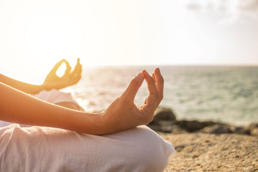 A close up of the hands of a person meditating