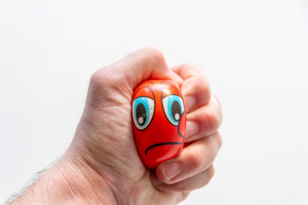 A hand squeezing a stress ball.